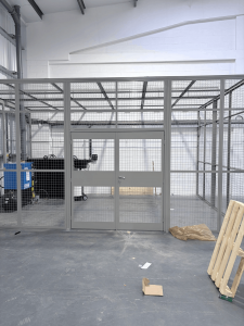 Full height steel mesh partitioning enclosure installed inside Clive Sutton’s workshop facility