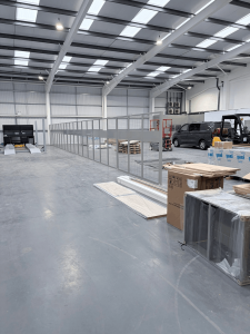 Steel mesh partitioning installation creating a secure enclosure inside Clive Sutton’s industrial workshop