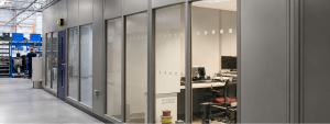 A double skin steel partitioning installation in an industrial warehouse environment.